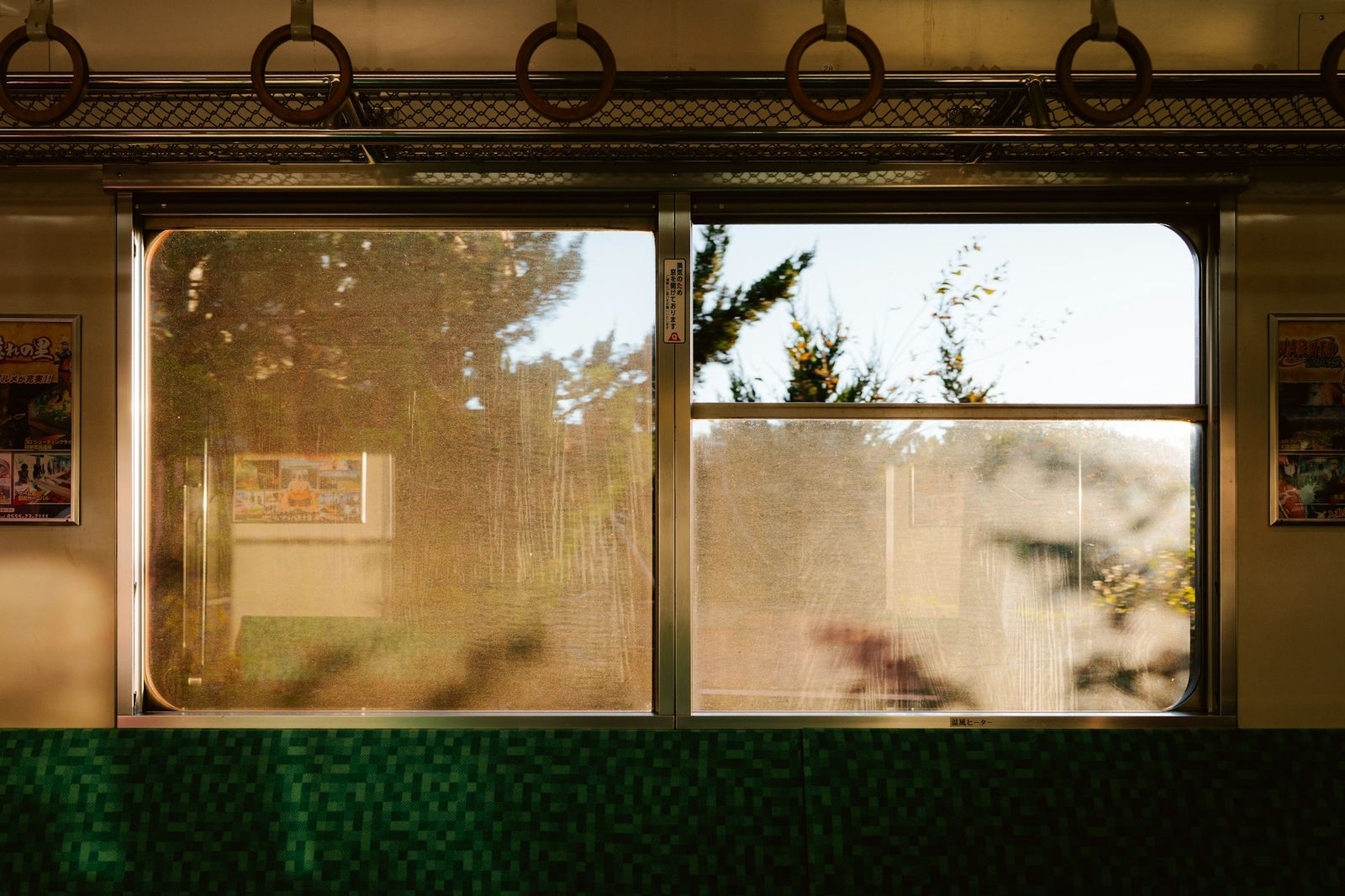 Late sunlight through the windows of a quiet local train